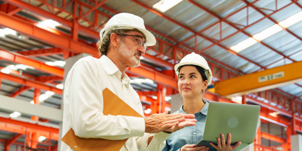 Two operatives plan in an industrial hall