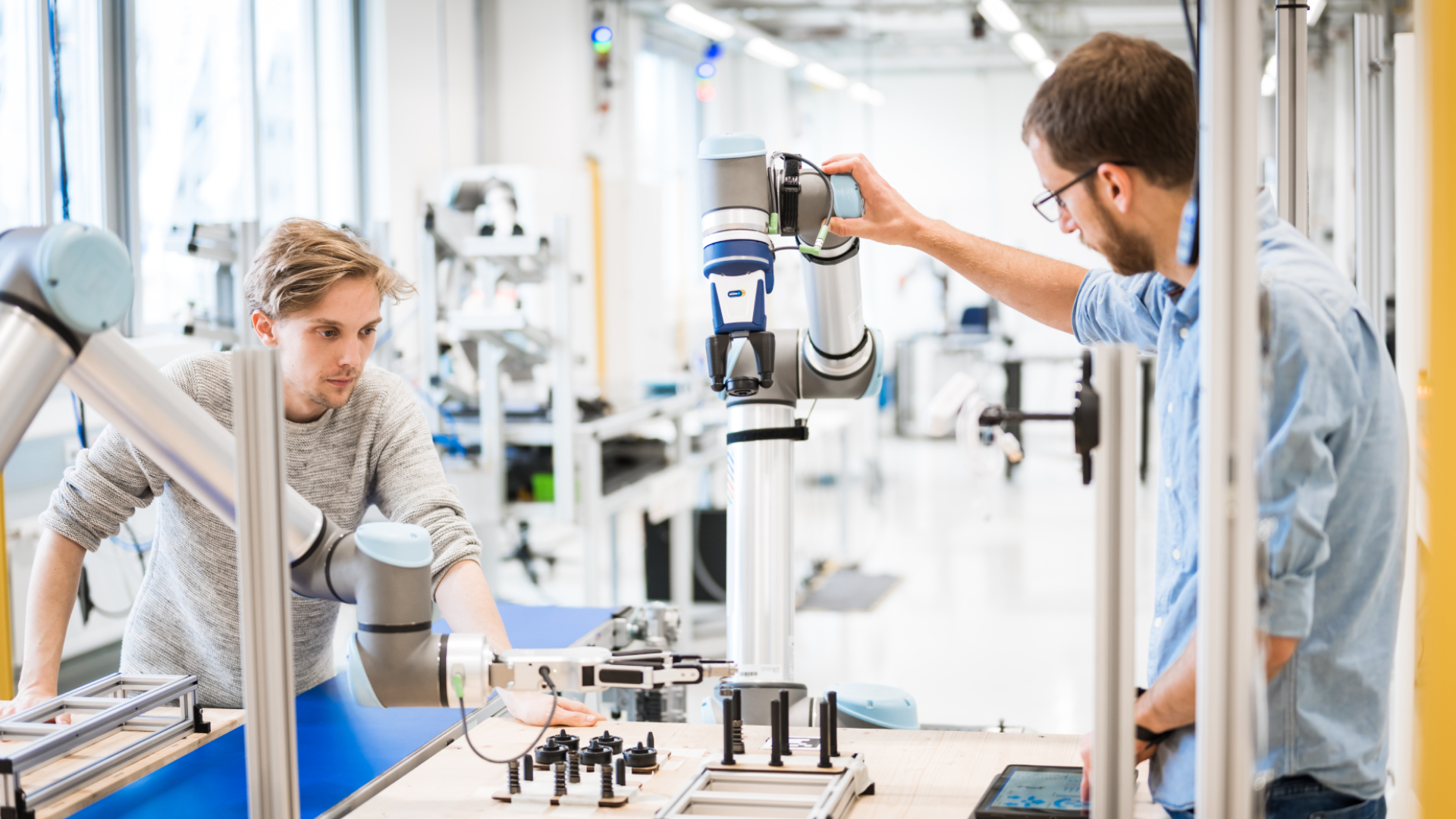 Two development engineers with robots